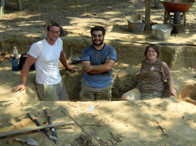 Students Ben Garbart, Ben Pollack and Jean Drzyzgula stand in the completed cellar excavation. 