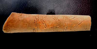 Decorated terra cotta pipe stem from the cellar hole fill.