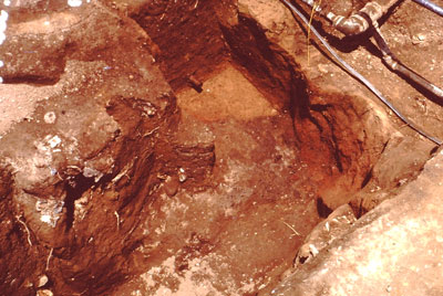  Northeast corner of the burned-clay cellar exposed at the bottom of a water pipe trench. 
