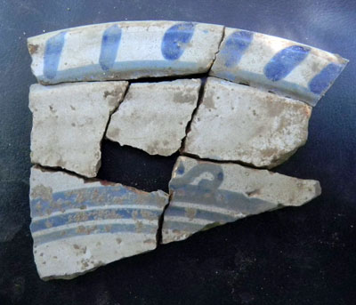 Fragments of a lead-backed, tin-glazed, earthenware plate.