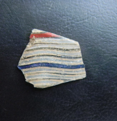 Red, white, and blue beaker fragment.