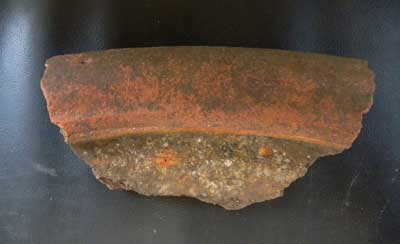 Rim sherd from a North Devon gravel-tempered vessel. 