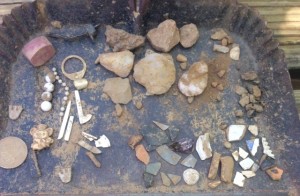 Assortment of artifacts, including modern plastic beads and some Native American lithic fragments